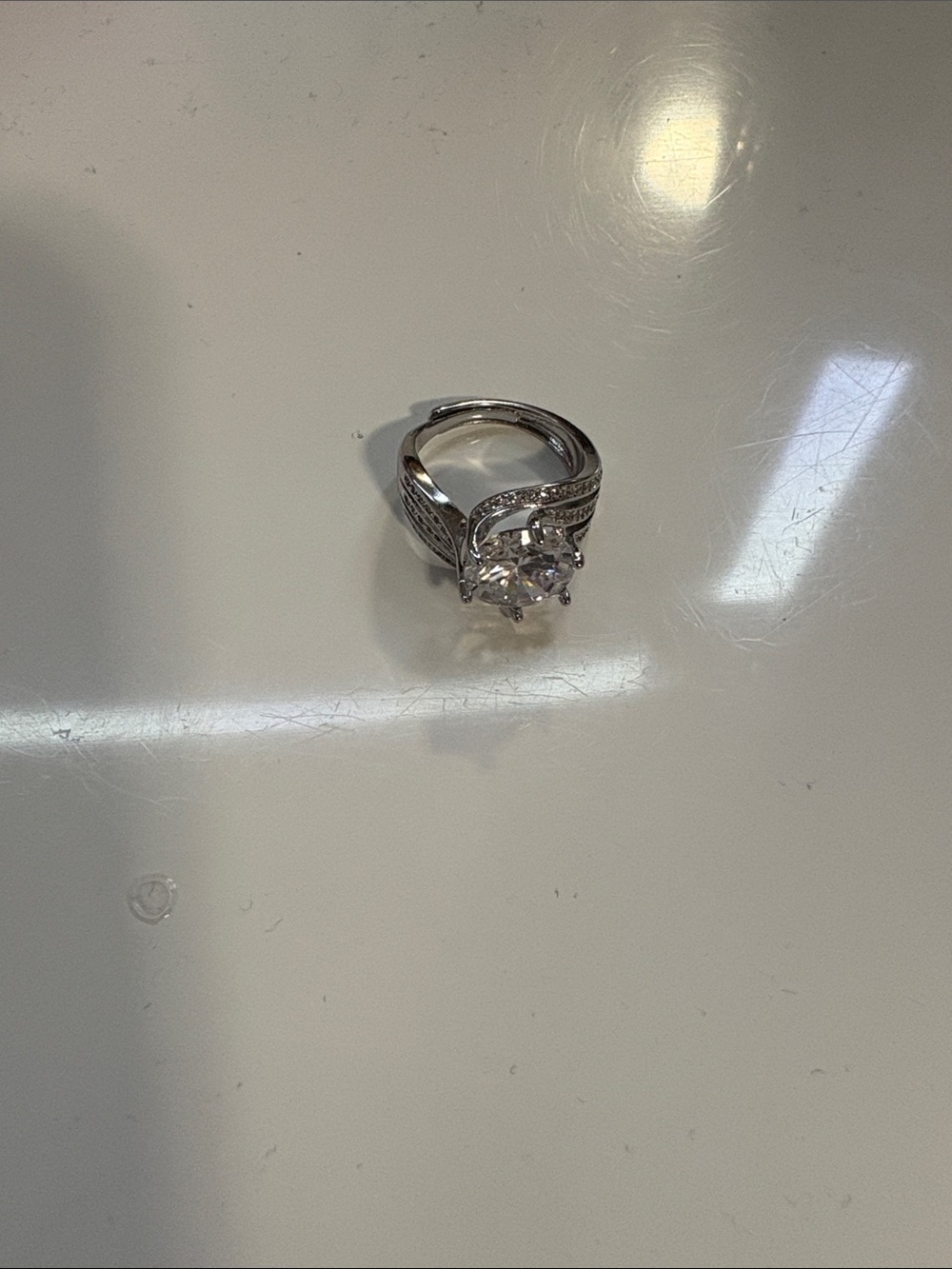 Silver-Tone White Crystal Solitaire Ring with Pavé Accents